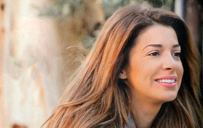 Κοντινό πλάνο της Ελένης Χατζίδου με μακριά καστανά μαλλιά.