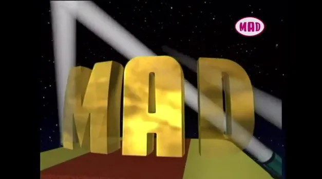 Το λογότυπο του MAD TV σε χρυσά τρισδιάστατα γράμματα στο διάστημα.