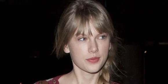 Η Taylor Swift με ξανθά μαλλιά και αφέλειες σε κοντινό πλάνο.