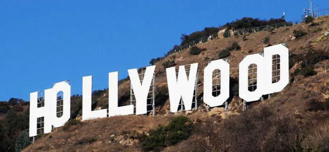 Η εμβληματική πινακίδα του Hollywood σε λόφο κάτω από γαλανό ουρανό.