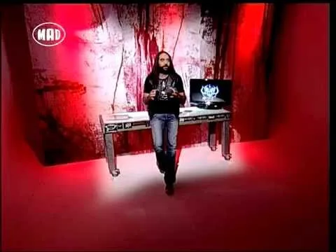 Παρουσιαστής της εκπομπής TV War σε στούντιο με κόκκινο φωτισμό.