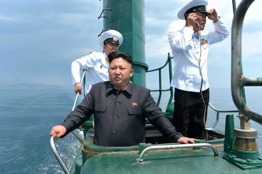 North Korean leader Kim Jong Un stands on the conning tower of a submarine during his inspection of the KPA Naval Unit 167