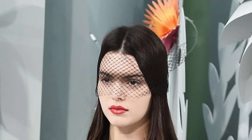 Η Kendall Jenner στην πασαρέλα του οίκου Chanel με μαύρο πέπλο και κόκκινο κραγιόν.