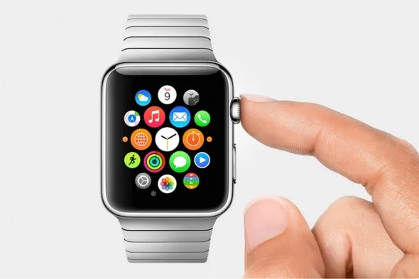 Κοντινό πλάνο ενός Apple Watch με μεταλλικό μπρασελέ και ένα δάχτυλο να αγγίζει την ψηφιακή κορώνα.