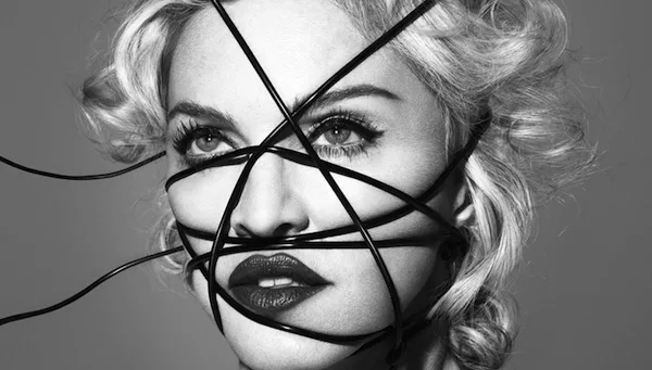Ασπρόμαυρο κοντινό πορτρέτο της Madonna με μαύρα καλώδια τυλιγμένα γύρω από το πρόσωπό της.
