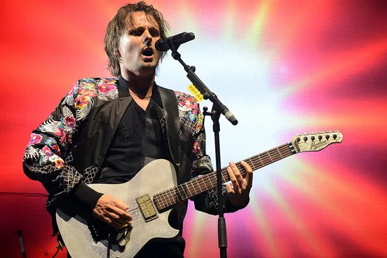 Ο Matt Bellamy των Muse τραγουδάει και παίζει κιθάρα σε συναυλία.