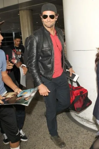 Bradley Cooper has his hands full after a long flight