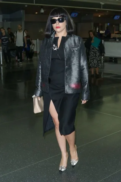 Lady Gaga is seen strolling through JFK Airport, showing off her engagement ring and outfit