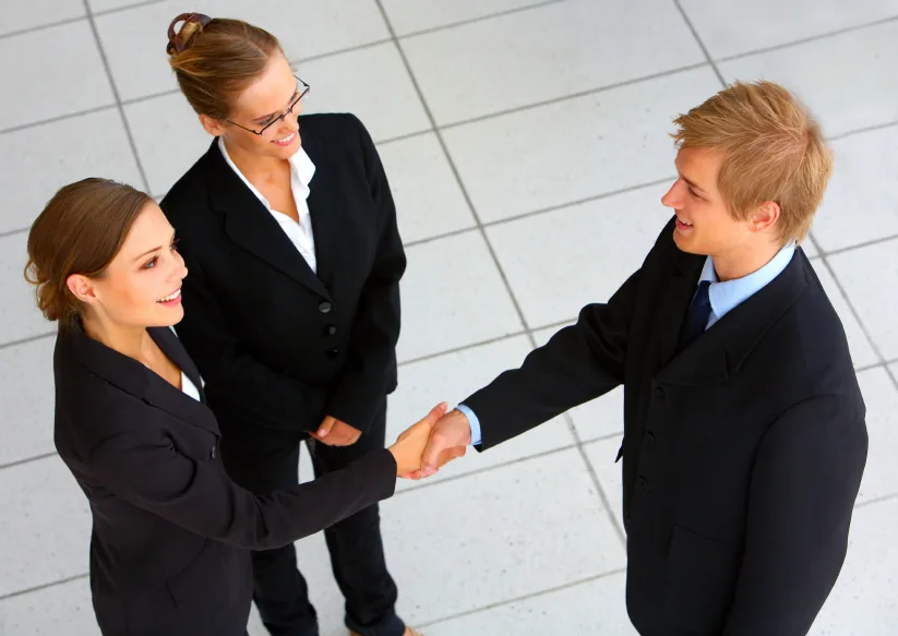 Businessteam wrapping up a meeting with handshake