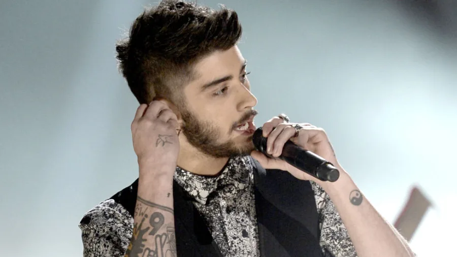Ο Zayn Malik τραγουδάει σε μικρόφωνο.
