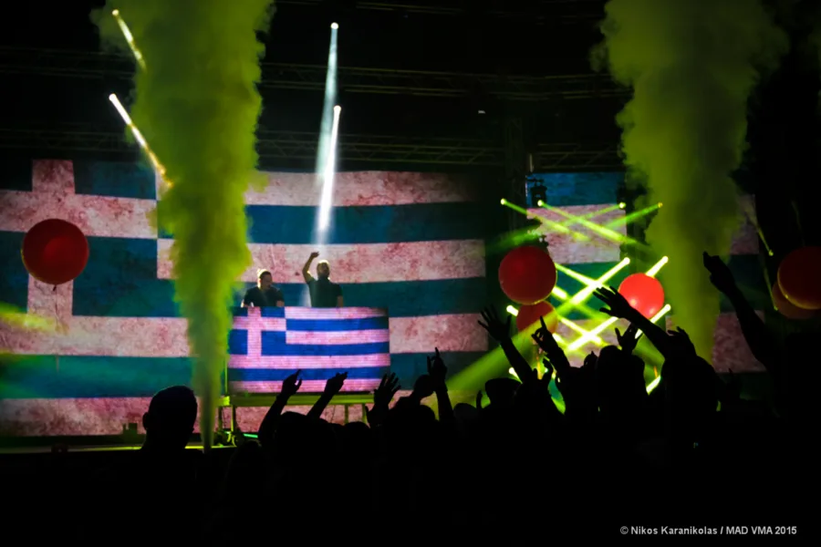 Οι Dimitri Vegas & Like Mike στη σκηνή των Mad VMA 2015 με την ελληνική σημαία στο φόντο.