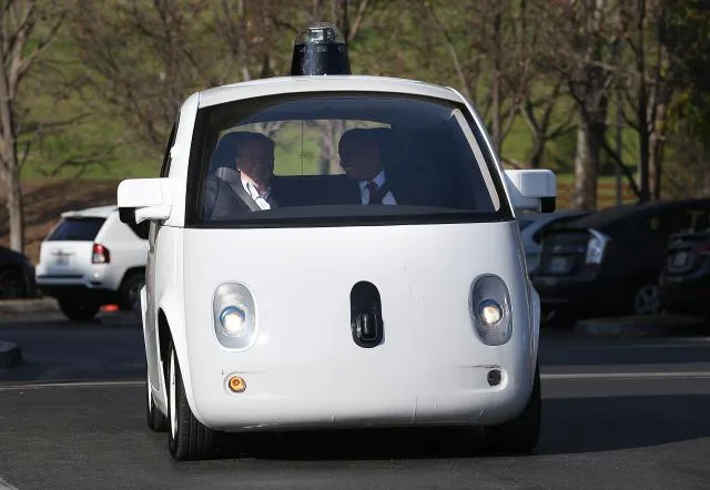 MOUNTAIN VIEW, CA - FEBRUARY 02: U.S. Transportation Secretary Anthony Foxx (R) and Google Chairman Eric Schmidt (L) ride in a Google self-driving car at the Google headquarters on February 2, 2015 in Mountain View, California. U.S. Transportation Secretary Anthony Foxx joined Google Chairman Eric Schmidt for a fireside chat where he unveiled Beyond Traffic, a new analysis from the U.S. Department of Transportation that anticipates the trends and choices facing our transportation system over the next three decades. (Photo by Justin Sullivan/Getty Images)