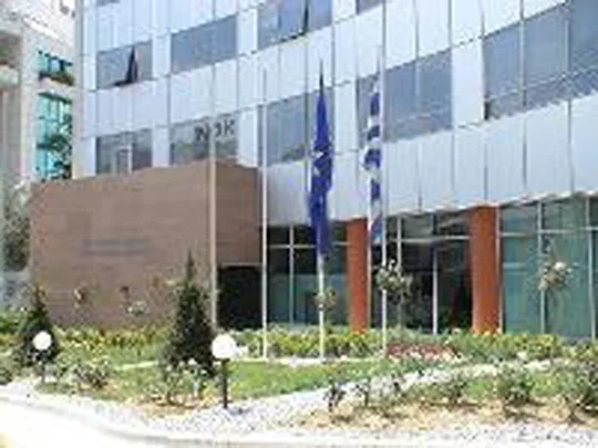 Το κτίριο της Γενικής Γραμματείας Ενημέρωσης και Επικοινωνίας με σημαίες στην είσοδο.