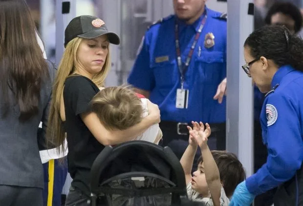 EXCLUSIVE: Shakira makes her way through Miami airport with her two sons Milan and Sasha.