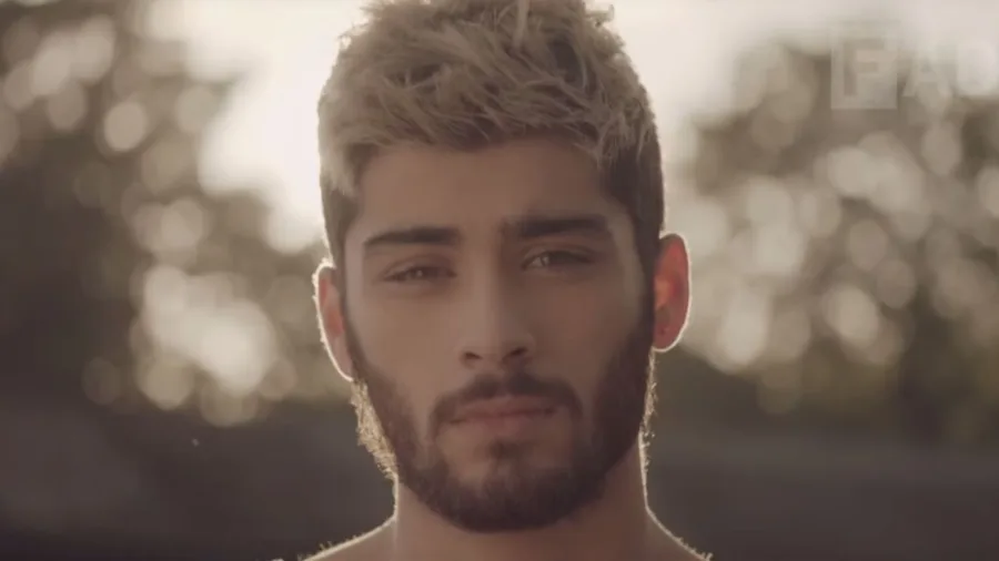 Ο Zayn Malik με ξανθά μαλλιά και μούσι σε εξωτερικό χώρο.