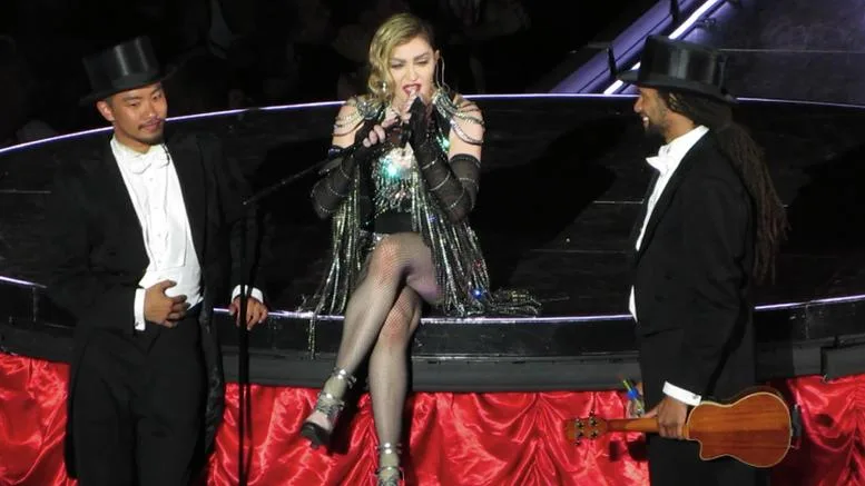 Η Madonna στη σκηνή της περιοδείας Rebel Heart ανάμεσα σε δύο χορευτές.