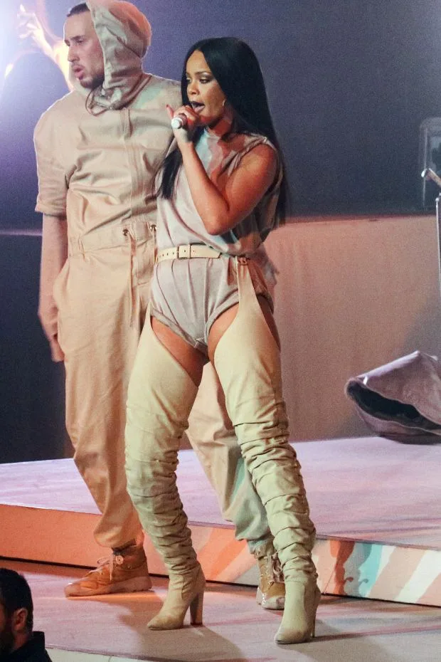 Pop superstar singer Rihanna brought her Anti Tour to Seattle on Sunday night. The 'Diamonds' singer had four or five costume changes, from a post-apocalyptic leather ensemble, to a sequin pant-suit to an oversize mens suit and leather bustier. Running th