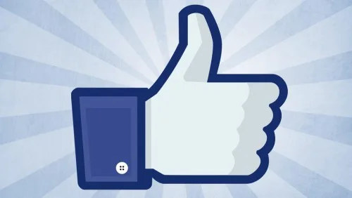 Το εικονίδιο Like του Facebook σε γαλάζιο φόντο με ακτίνες.