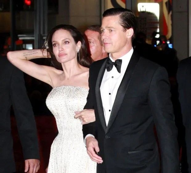 NO JUST JARED USAGEAngelina Jolie dazzles in white jewel encrusted gown husband Brad Pitt looks dapper in black tuxedo for LA By The Sea premierePictured: Brad Pitt, Angelina JolieRef: SPL1170958 061115 Picture by: Splash News<B