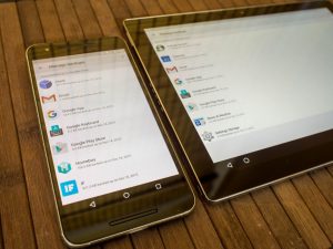 Ένα smartphone και ένα tablet με Android πάνω σε ξύλινη επιφάνεια.