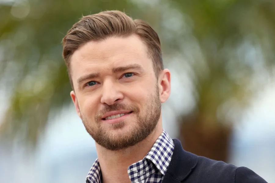 Ο Justin Timberlake με κοντό κούρεμα και μούσι, φορώντας καρό πουκάμισο.