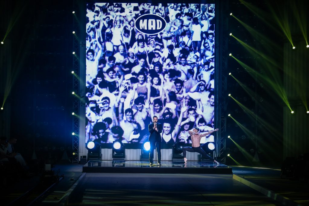 Καλλιτέχνης τραγουδά στη σκηνή του MadWalk 2017 με χορευτή και φόντο πλήθος κόσμου.