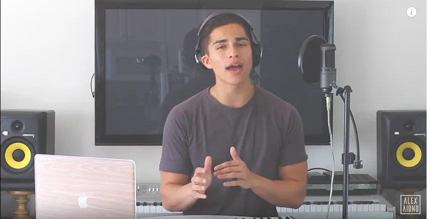 Ο Alex Aiono σε στούντιο ηχογράφησης με ακουστικά και μικρόφωνο.
