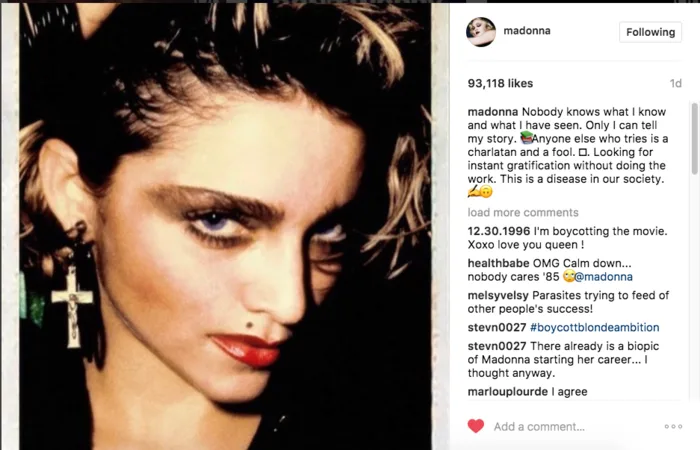 Κοντινό πλάνο της Madonna από τη δεκαετία του '80 με σκουλαρίκι σταυρό.