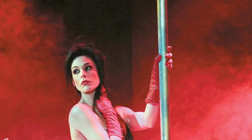 Η Ιωάννα Τριανταφυλλίδου σε στύλο pole dancing με κόκκινα γάντια.