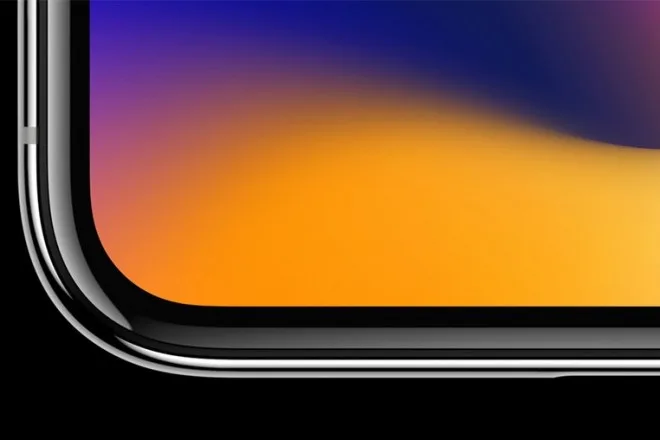 Κοντινό πλάνο στη γωνία ενός iPhone X με πολύχρωμη οθόνη.