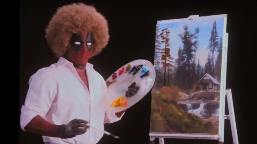Ο Deadpool μεταμφιεσμένος σε Μπομπ Ρος μπροστά από έναν καμβά.
