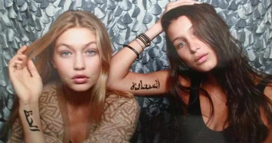 Η Gigi και η Bella Hadid ποζάρουν μαζί με προσωρινά τατουάζ στα χέρια τους.