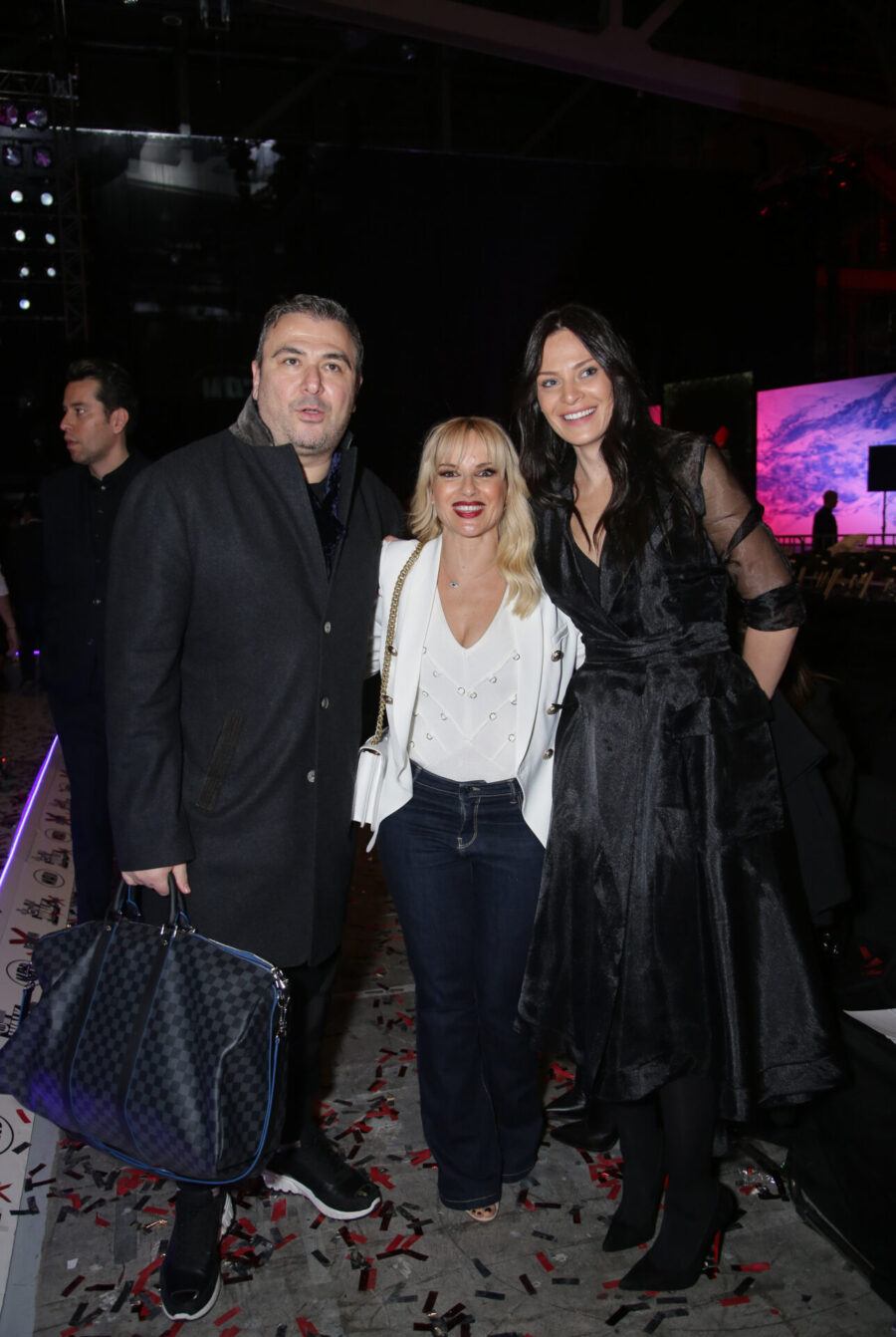 Τρία άτομα ποζάρουν στο after party του MadWalk.