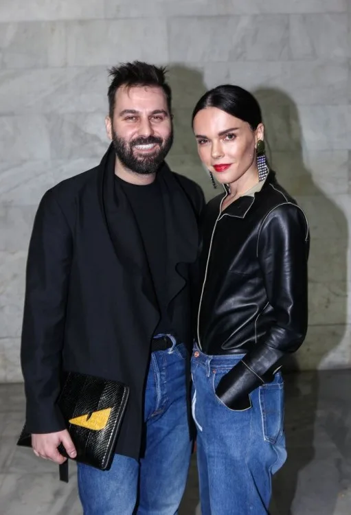 Ένας άνδρας και μια γυναίκα ποζάρουν μαζί σε εσωτερικό χώρο.