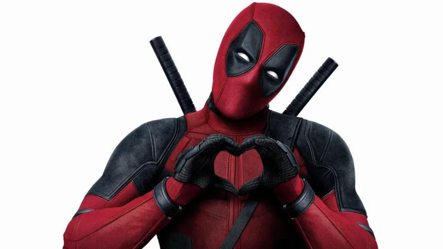 Ο Deadpool σχηματίζει μια καρδιά με τα χέρια του.