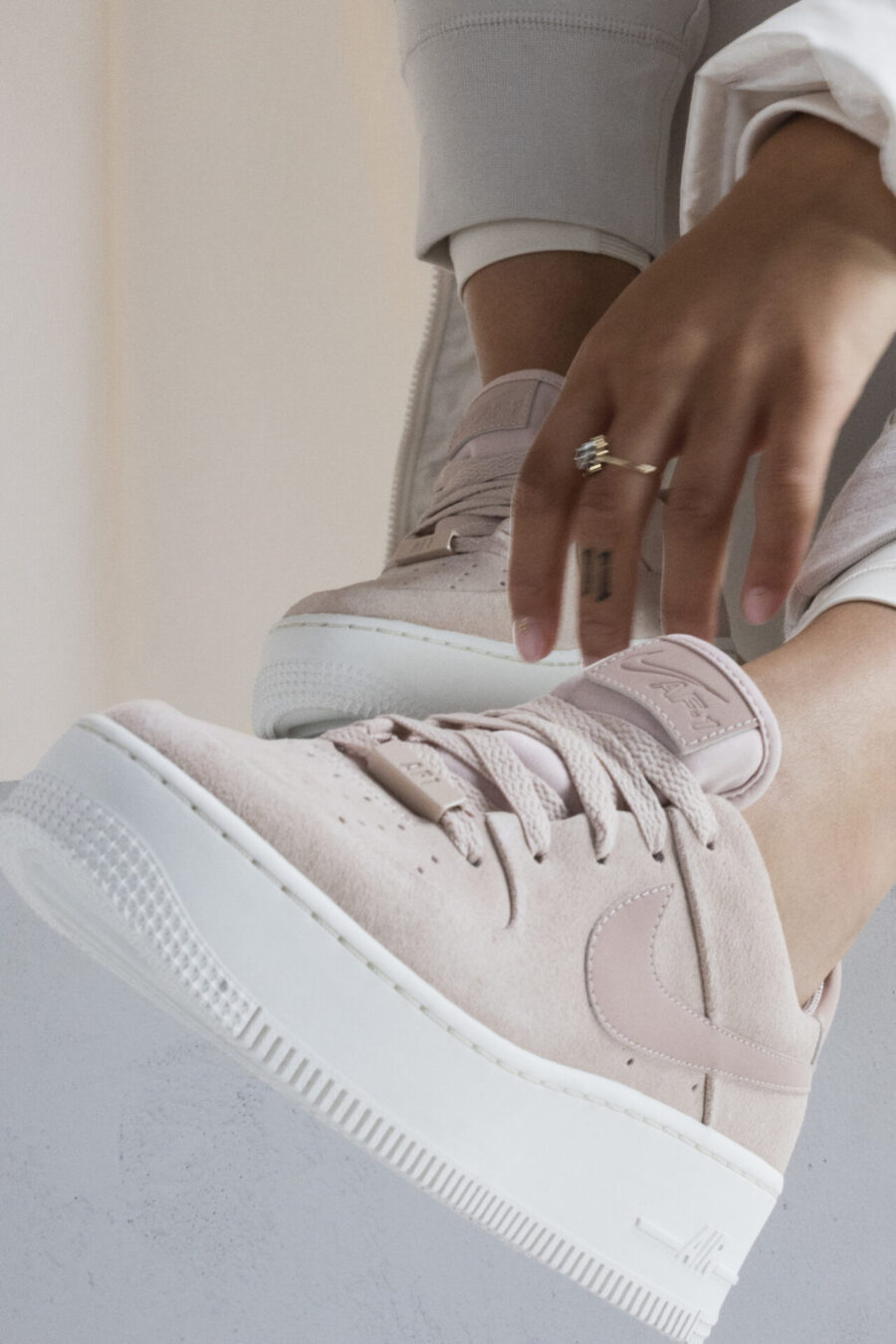 Κοντινό πλάνο στα Nike Air Force 1 Sage σε απαλό ροζ χρώμα.