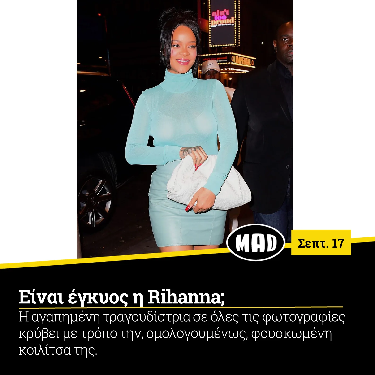 Η Rihanna με γαλάζιο ζιβάγκο και φούστα κρατώντας λευκή τσάντα.