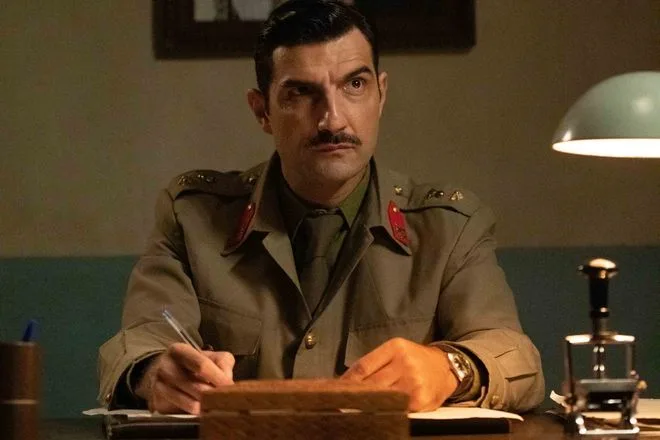 Άνδρας με στρατιωτική στολή και μουστάκι σε γραφείο από τη σειρά Άγριες Μέλισσες.