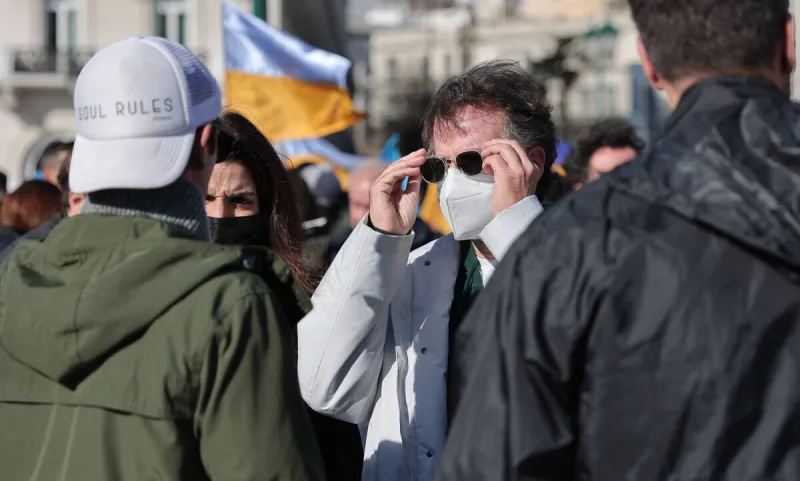 Άνδρας με μάσκα προστασίας και γυαλιά ηλίου σε αντιπολεμική συγκέντρωση στην Αθήνα.