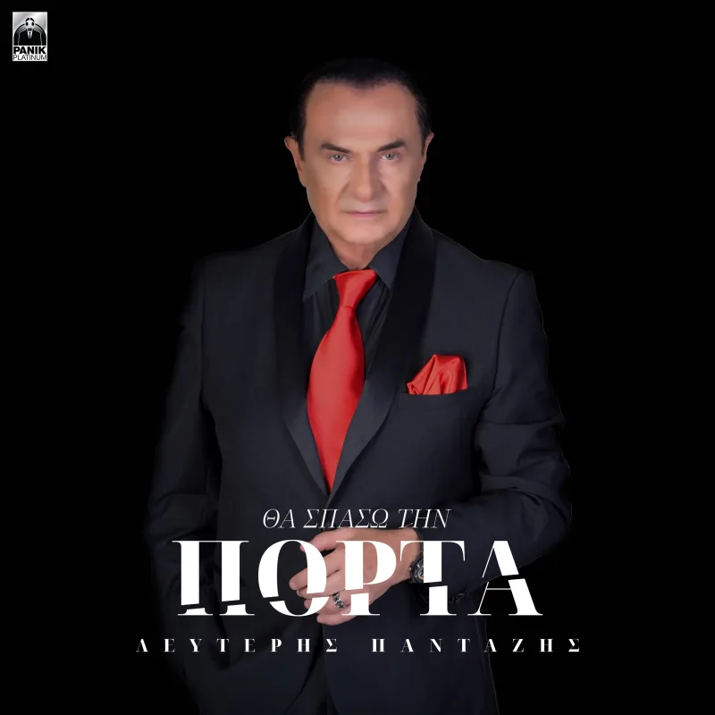 Ο Λευτέρης Πανταζής με μαύρο κοστούμι και κόκκινη γραβάτα σε μαύρο φόντο.