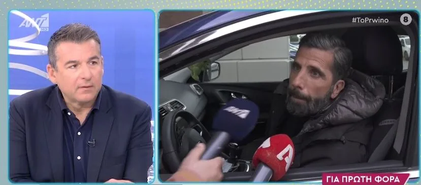 Ο Θανάσης Βισκαδουράκης δίνει συνέντευξη μέσα από το αυτοκίνητό του.