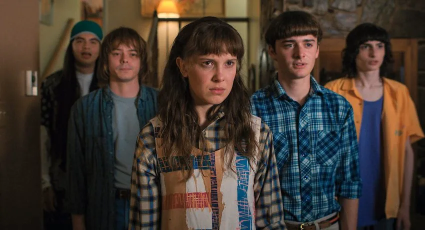 Πρωταγωνιστές της σειράς Stranger Things σε εσωτερικό χώρο.