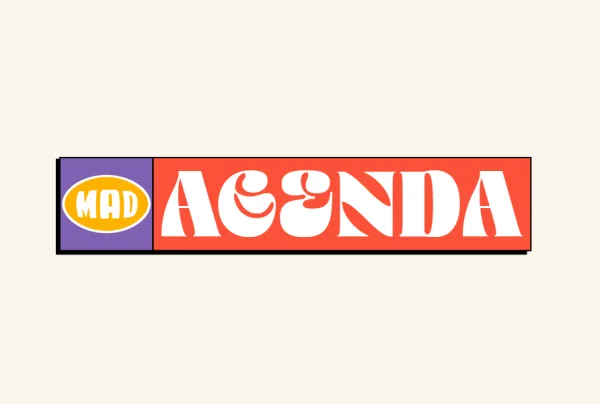 Λογότυπο Mad Agenda σε κόκκινο και μωβ φόντο.