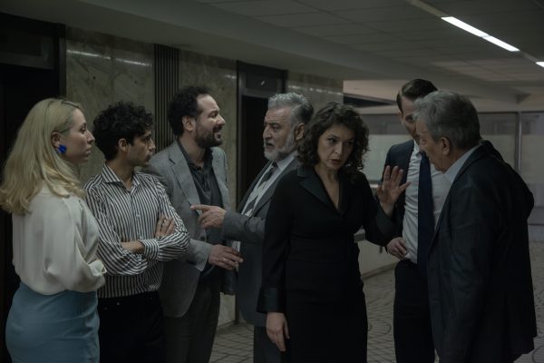 Σκηνή από την παράσταση «Εχθρός του λαού» με ομάδα ηθοποιών σε έντονη συνομιλία.