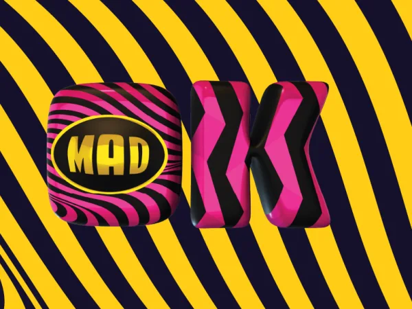 Το λογότυπο MAD TV σε 3D μορφή με ροζ και μαύρες ρίγες σε κίτρινο φόντο.
