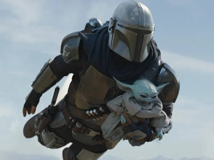 Ο Mandalorian πετάει στον αέρα κρατώντας τον Grogu
