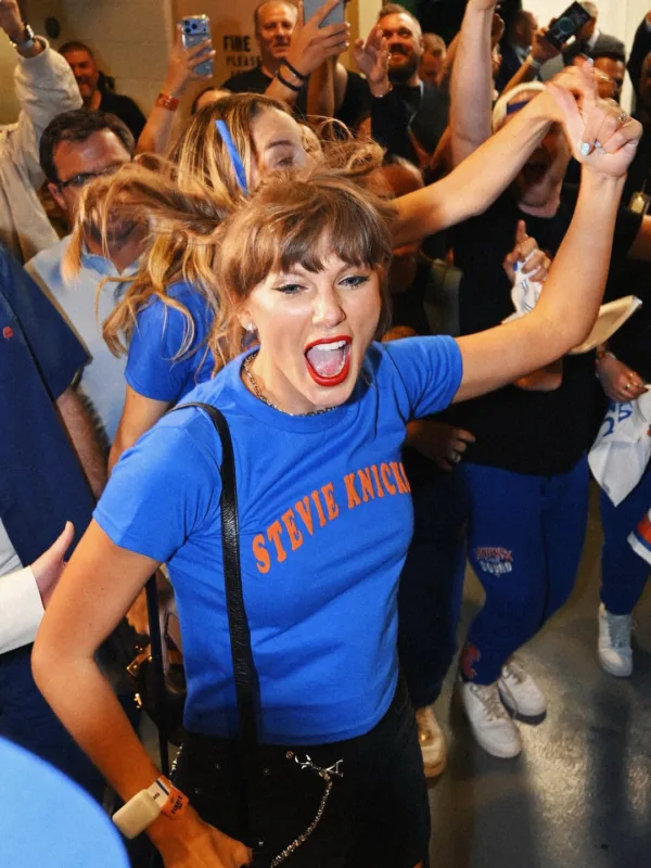 Η Taylor Swift με μπλουζάκι Stevie Knicks πανηγυρίζει στον τελικό του ΝΒΑ, ανάμεσα σε πλήθος αστέρων.