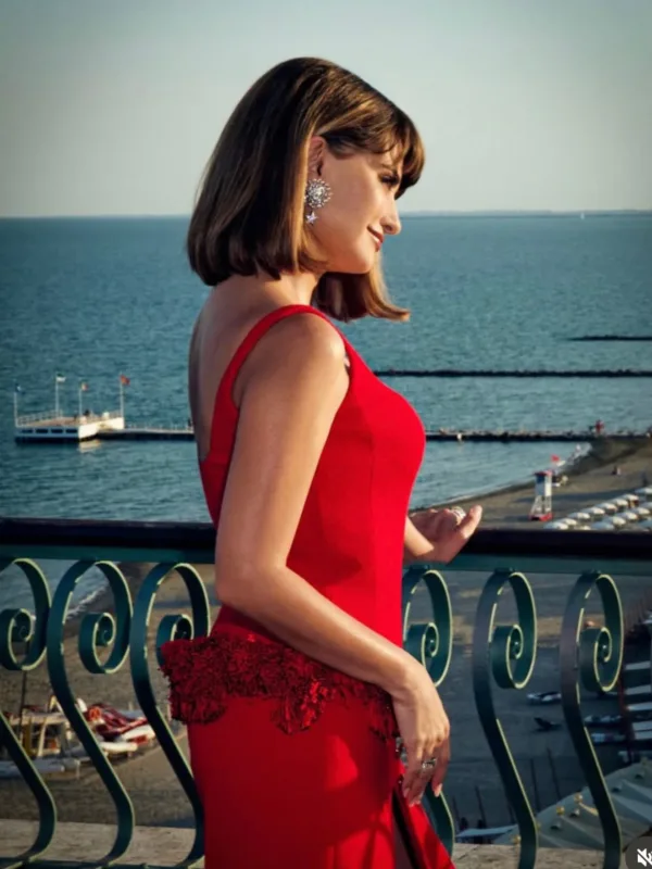 Η Penélope Cruz με κόκκινο φόρεμα απολαμβάνει τη θέα στη θάλασσα, μιλώντας δημόσια για όσα την απασχολούν.